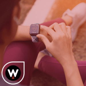 women looking at health rate on smart watch before working out wiegers financial and benefits logo in corner