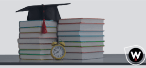 pile of books with a alarm clock in front and a graduation cap on top of the books