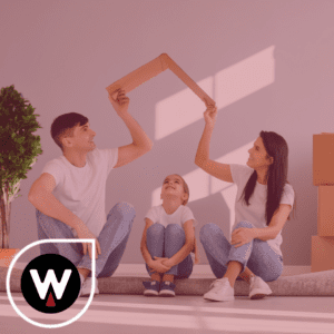 family sitting on floor in home holding house roof over child signifying financial safety through life insurance 