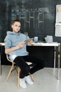 boy holding ipad in classroom